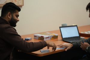 am man is using his phone on the table of system